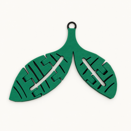 Green-and-black articulated Sprout trinket shown from the front on a neutral background