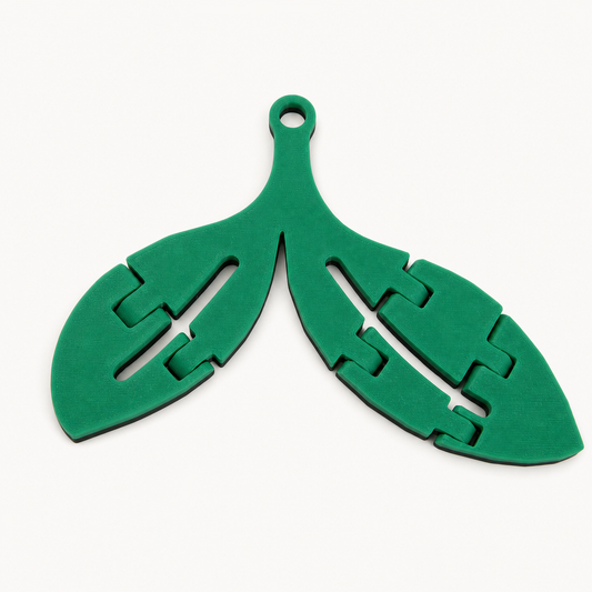Back of the green-and-black articulated Sprout trinket showing its hanging loop and construction